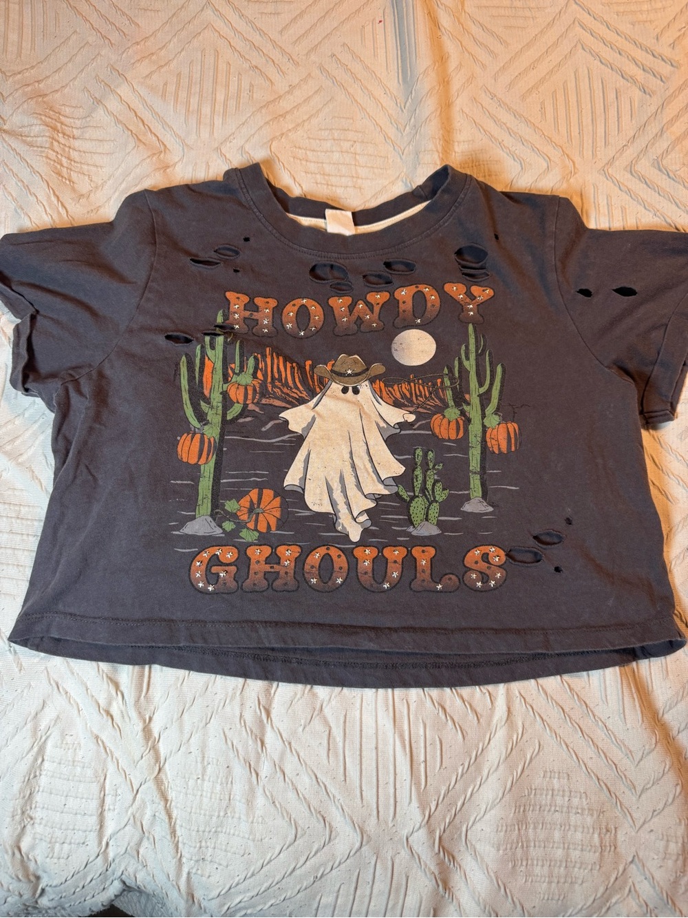 Cropped t-shirt featuring distressed finish with cowboy ghost graphic